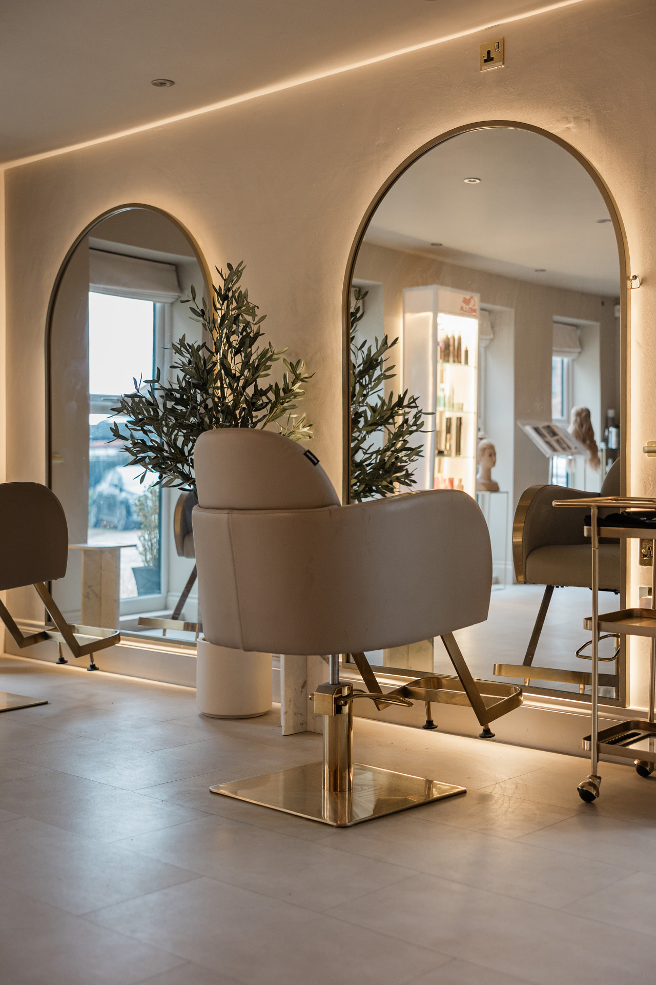 The Couture Bridal Hair studio interior, with arch-shaped mirrors and styling chairs.