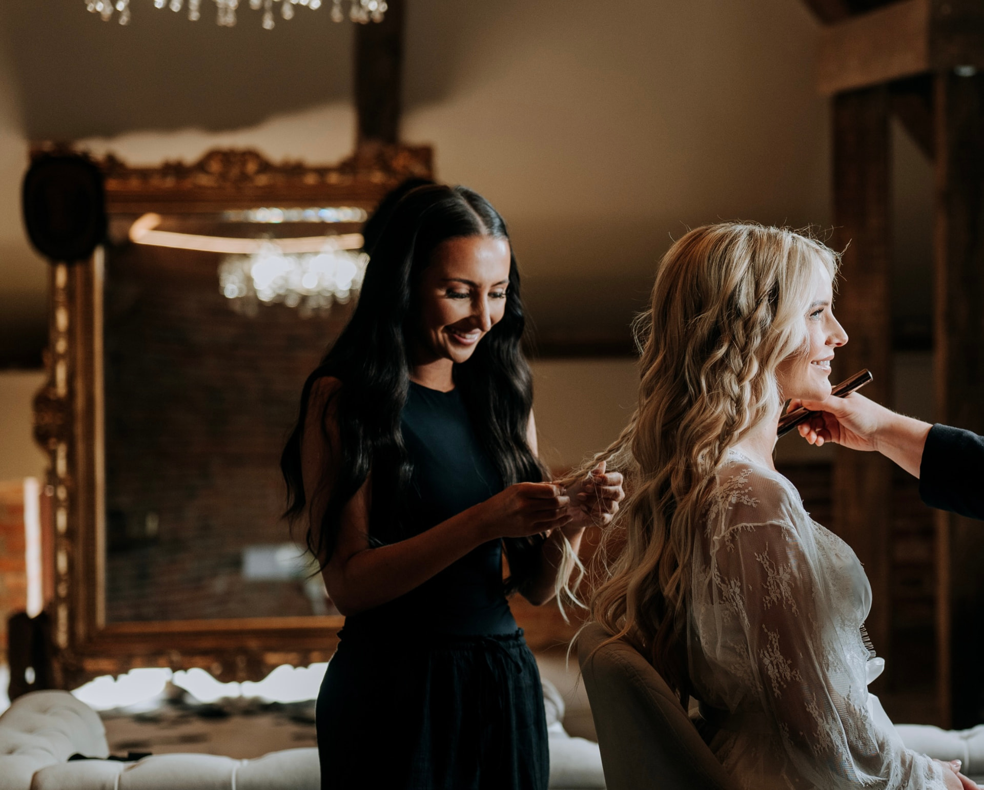 Georgia refining a blonde bride's hair in the softly lit Couture studio.